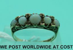 A 9ct gold ring set with five opal cabochons (size M)
