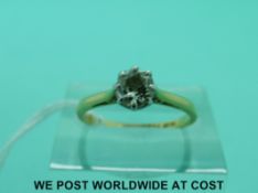 An 18ct gold ring set with a diamond solitaire, approximately 0.