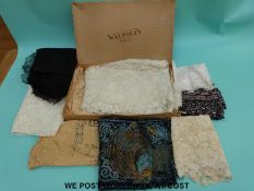 A vintage Walpoles of Dublin box containing a quantity of lace including a black shawl silk lining,
