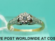 An 18ct gold ring set with a diamond in a platinum setting (size N)