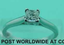 An 18ct white gold ring set with a princess cut diamond of approximately 0.