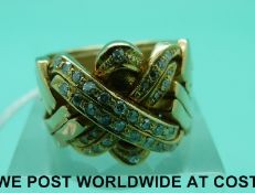 A yellow metal ring set with diamonds in a multi layered plaited design (16g,