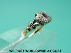 An 18ct gold ring set with a ruby and diamonds in a platinum setting (size K)