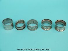 Five various hallmarked silver napkin rings to include a boxed pair and a feature hallmarked