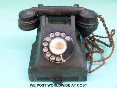 A vintage black bakelite telephone marked 332F to underside