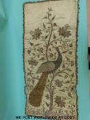 A mid Victorian (circa 1850) wall hanging embroidery on silk of a peacock among stylised foliage,