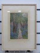 A framed embroidery of a bluebell wood