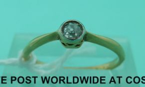 An 18ct gold ring set with a diamond of approximately 0.