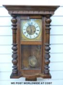 A c1910 two train wall clock in half bobbin turned case,