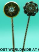 A Victorian stick pin set with an old mine cut diamond in a star setting on a circular mount and an