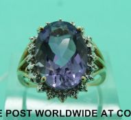 A 9ct gold ring set with an amethyst and two small diamonds (size P)