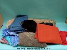 A box containing a quantity of fabric for dress making to include various lining material,