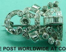 A platinum brooch set with round cut and baguette cut diamonds