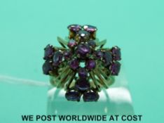 A yellow metal ring set with pink sapphires in a Maltese Cross shape (size P)