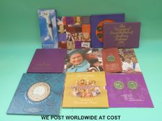 A selection of brilliant coin sets, five pound crowns, USA silver eagle dollar etc.