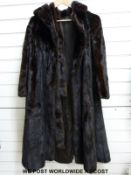 A vintage ladies long fur coat with belt