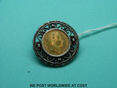 An 1877 five mark gold coin in mount