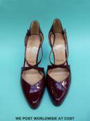 A pair of Christian Louboutin maroon leather stiletto court shoes, size 39.