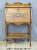 An oak Art Nouveau style ladies writing desk with fitted interior and undershelf (W70 x D36 x