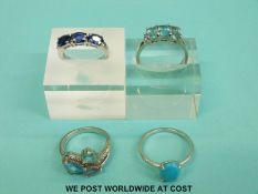 Four silver rings variously set with blue topaz, turquoise, aquamarine and sapphires (11.