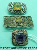 Three white metal brooches set with various stones