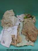 A small collection of linen and lace and a child's jacket
