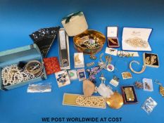 A large collection of costume jewellery to include agate necklace, beaded necklaces, faux pearls,