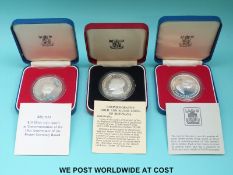 Three cased silver crown sized coins comprising Botswana,