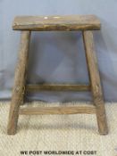 A 19thC elm jointed stool or coffin trestle (51cm tall)