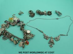 A silver charm bracelet, marcasite necklace,