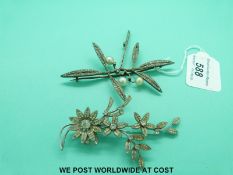 A large silver brooch in a foliate design and a paste brooch in the form of flowers