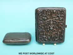 An Indian white metal cigarette case with deep embossed decoration of Hindu gods including Ganesh,