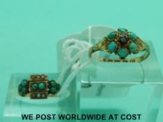 A 15ct gold ring set with a garnet surrounded by turquoise cabochons,