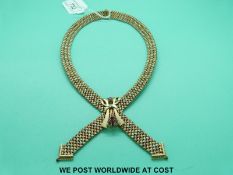 A 9ct gold tri-coloured necklace in a plaited design set with rubies (79g)