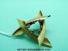 A yellow metal brooch marked 18ct set with rubies (10.