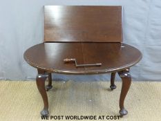 A mahogany dining table with spare leaf raised on cabriole legs (L134 x W107 x H72cm)