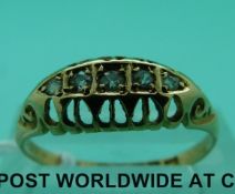 An 18ct gold ring set with five diamonds,