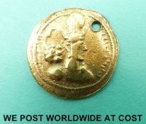 An Ancient gold coin, bust with high crown, ear ring, and a bunch of grapes left,