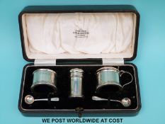 A cased three piece hallmarked silver cruet set (one spoon silver,