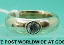 A white metal ring set with a diamond of approximately 0.