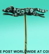 A Victorian yellow metal stick pin in the form of a fox set with rose cut diamonds and a ruby eye