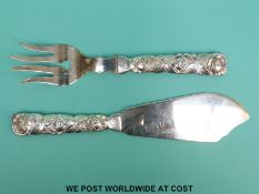 A pair of Finnish white metal fish servers with Art Nouveau style handles in the manner of Georg
