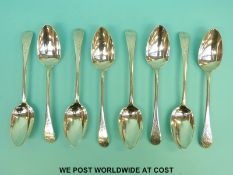 A set of eight Georgian hallmarked silver bright cut table spoons,