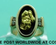 A 14ct gold ring set with a large gold nugget and four diamonds (1.