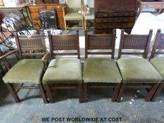 A set of eight (2+6) carved oak upholstered dining chairs with panel backs and reeded legs