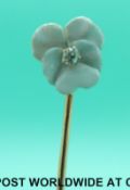 A stick pin in the form of a pansy set with white enamel to the petals and an old cut diamond to