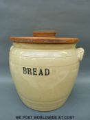 A very large ceramic bread bin with wooden lid stamped to underside 