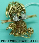 An 18ct gold brooch in the form of a lion set with diamonds and emeralds,