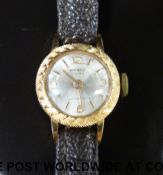 Normale 18ct gold ladies wristwatch with gold hands and markers and textured bezel,