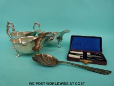 Three silver plated sauce boats together with a cased sewing set, hair pin pot etc.